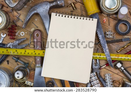 Home maintenance - An untidy workbench full of dusty old tools and screws with space for text.