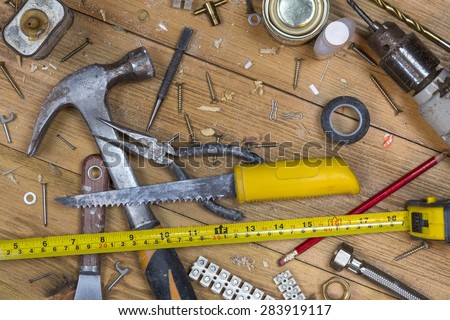 Home maintenance - An untidy workshop bench full of dusty old tools and screws.