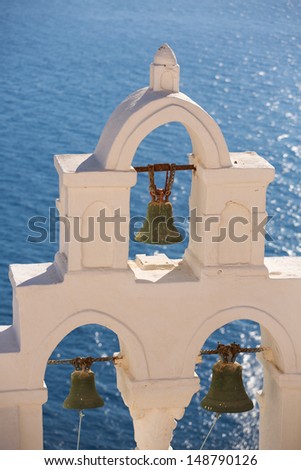 Close up of a Green bronze bells of a orthodox church in Santorini. There are many small churches all over Santorini. Pictured here is the Greek Orthodox church in Oia. .Greece, 2013.