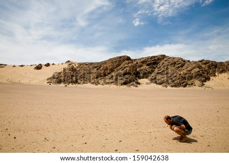 SKELETON COAST DESERT, NAMIBIA, DECEMBER 18: unidentified man searching the sand for diamonds in the forbidden diamond area in Namibia, December 18, 2006.