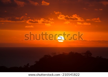 Sunset over Costa Rica. Sun reaching ocean through the clouds, Matapalo, Costa Rica 2013