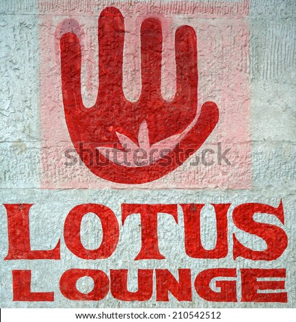 Words Lotus Lounge and lotus sign painted on old wall in Varanasi, India.