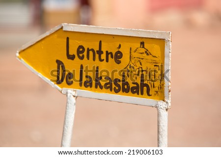 Old yellow Open sign to the fortified city in Ait-ben-Haddou, a fortified city, or ksar, along the former caravan route between the Sahara and Marrakech. Ait Benhaddou is UNESCO World Heritage site
