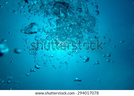 Air bubbles floating up through blue sea water, Galapagos Islands, Ecuador 2015.