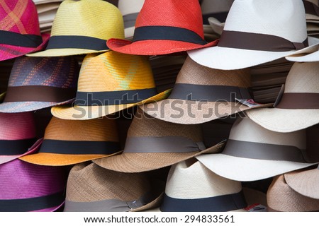 Group of colored hats for sale, hanging on a wall, Otavalo Market. Ecuador