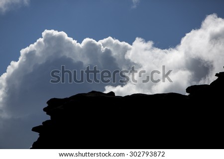 The silhouette of the cliffs of Kukenan tepui or Mount Roraima  with clouds and blue sky. Gran Sabana. Venezuela 2015.