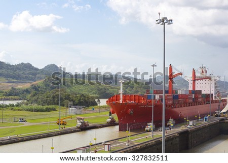 PANAMA CITY, PANAMA, JANUARY 3: Red Cap Stewart container ship entering in the basin of Miraflores Locks Panama Canal filling to raise a ship. Panama City, Panama 2014.