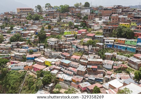 CARACAS, VENEZUELA, APRIL 20: Small wooden colored houses in the poor neighborhood in Caracas. It cover the hills around Caracas and it is dangerous at all times. Venezuela 2015