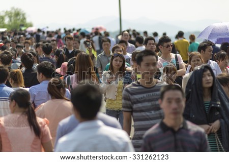 HANGZHOU, CHINA, MAY 1: Crowd walking along the lake in Hangzhou on the 1st of May, the Labour Day in China, 2013 (Selective focus)