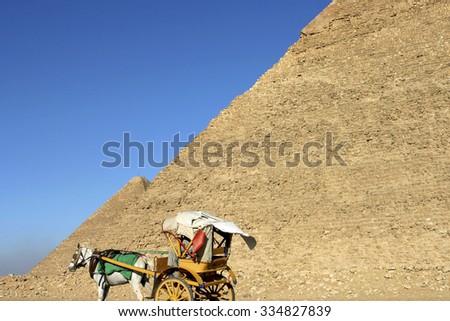 CAIRO, EGYPT, MARCH 20: Detail of Great Pyramid of Giza with a clear blue sky in the background and vintage horse carriage. The site is a UNSECO World heritage site. Egypt 2005