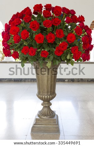 QUITO, ECUADOR, FEBRUARY 26: Huge bunch of red roses in stone vase located in the Presidential Palace, Quito. Ecuador 2015.