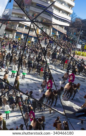 TOKYO, JAPAN, JANUARY 5: Reflection of the crowd into mirrors at shopping mall, busy crosswalk in Shibuya, Tokyo. Japan 2013
