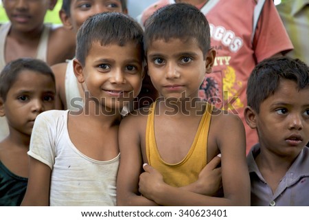 AGRA, INDIA, JULY 18: Group of happy Indian young boys posing in front of the camera living in a small village near Agra. India 2010.