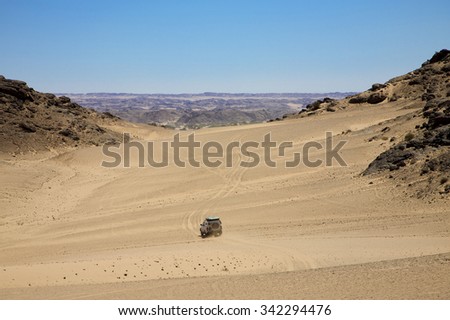 SKELETON COAST DESERT, NAMIBIA, JANUARY 11: 4x4 off-road car driving in the Skeleton Coast Desert with blue sky. Namibia 2010
