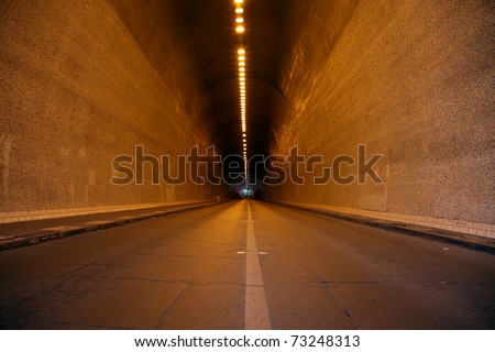 A long tunnel, people in the distance in Budapest