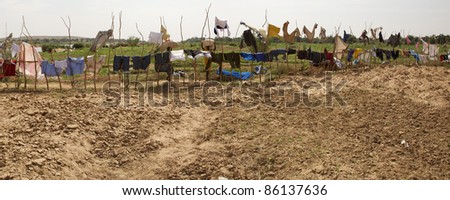 Panoramic view of clothes hanging and drying on pieces of wood in Senegal.