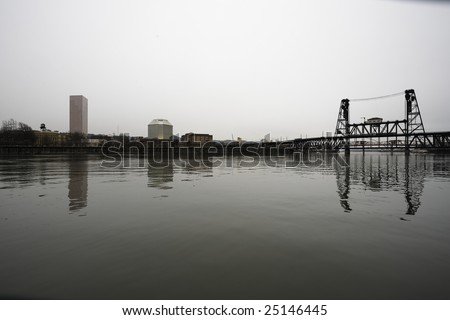 City scape along the waterfront\
\
Steel Bridge, Portland Downtown along the Willamette waterfront.