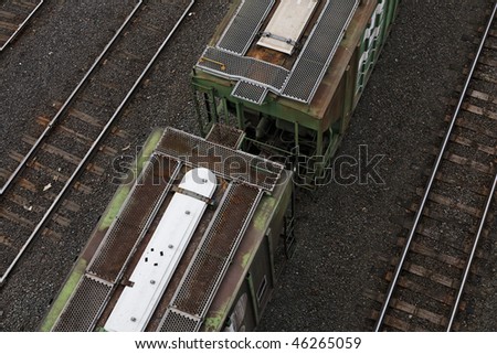 Two Railroad freight cars - view from high vantage point looking down on two coupled cars with slight movement