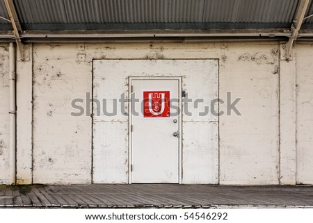 Industrial warehouse door and loading dock with metal corrugated awning overhead