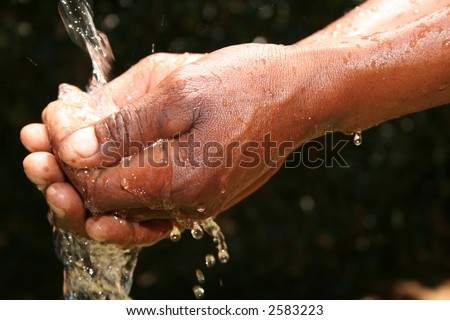 black man catching water in hand