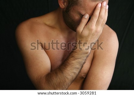 stock photo Nude male figure with hand in front of his face