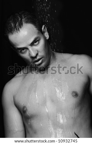 A sexy muscular young man in shower washing  himself (black and white)