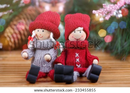 Small toy couple making sitting at christmas background