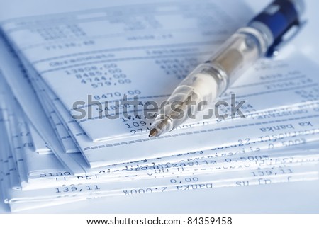 Banking reports on a folded sheets and pen