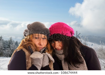 two woman in winter clothes and winter landscape