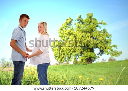 pregnant woman with her man in nature