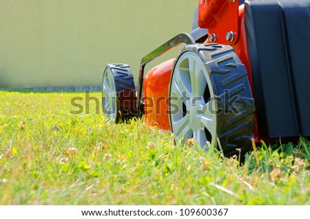lawn mower and green grass / lawn mower / gardening