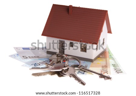 small house with banknotes and house keys / dream of own house