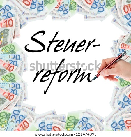 Hand with pen writes the german words tax Reform / tax Reform