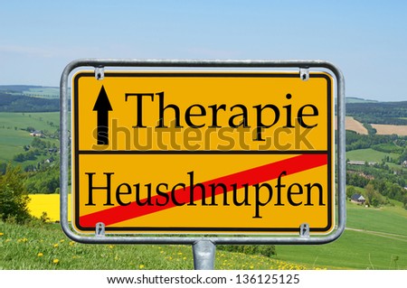 Landscape and Shield with the german words hay fever and therapy / hay fever and therapy