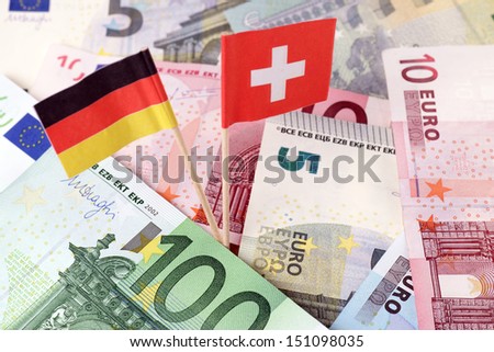 euro banknotes with germany flag and swiss flag / tax evasion