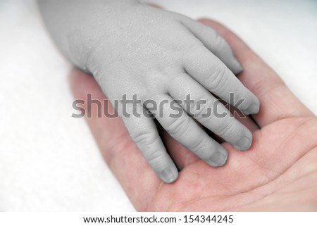 Hand of a baby in black and white and color / baby hand