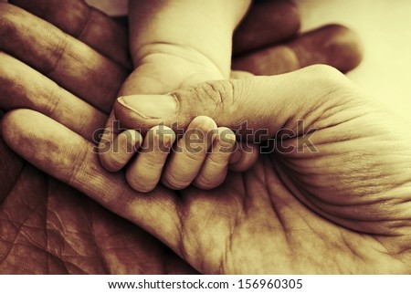 Hands holding a baby hand with a abstract filter / Family
