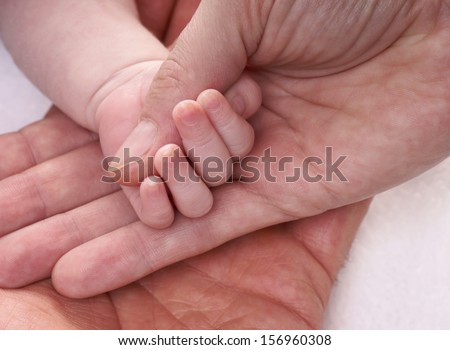 Hands holding a baby hand / Family