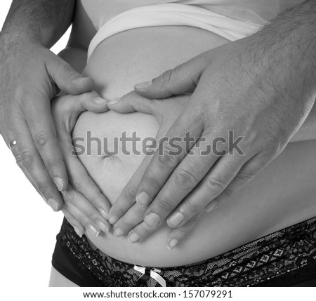 pregnant woman and hands from her husband in black and white / family