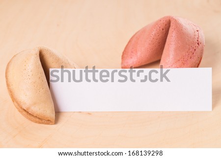 Fortune cookies with empty note over a wooden background / Fortune Cookies