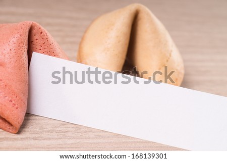 Fortune cookies with empty note over a wooden background / Fortune Cookies