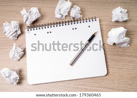 blank notepad with pen on a table / blank writing pad