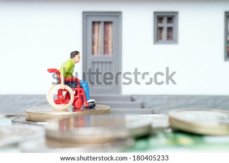Wheelchair user in front of a house / Wheelchair user