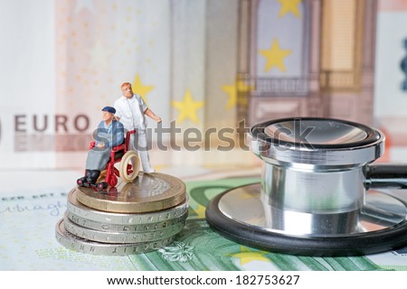 wheelchair user with nursing staff and euro money with stethoscope / wheelchair user