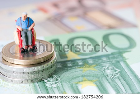 Old man in a wheelchair with money / wheelchair user
