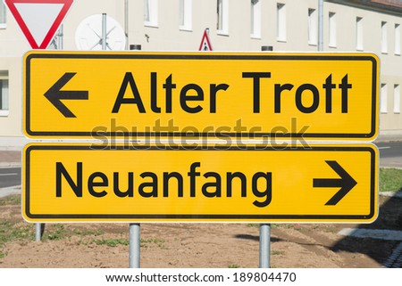 Sign with the german words Old routine and a new beginning / German sign