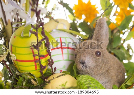 Easter eggs and Easter bunny with flowers / Easter