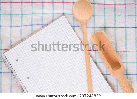 blank recipe book and wooden spoon / recipe book