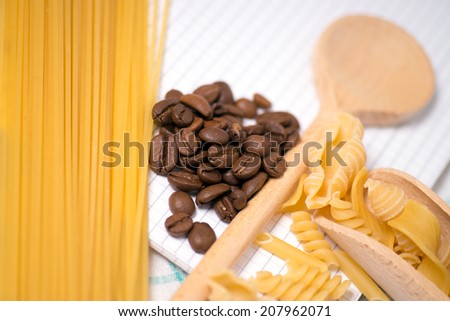 Wooden spoon with pasta and coffee beans / Pasta