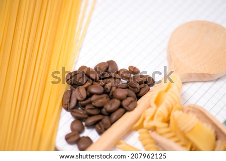 Wooden spoon with pasta and coffee beans / Pasta